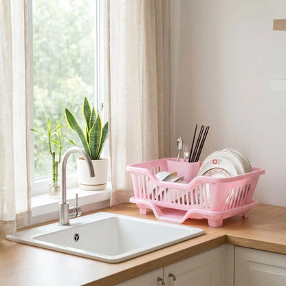 Égouttoir vaisselle drainage automatique rose sur comptoir avec plantes
