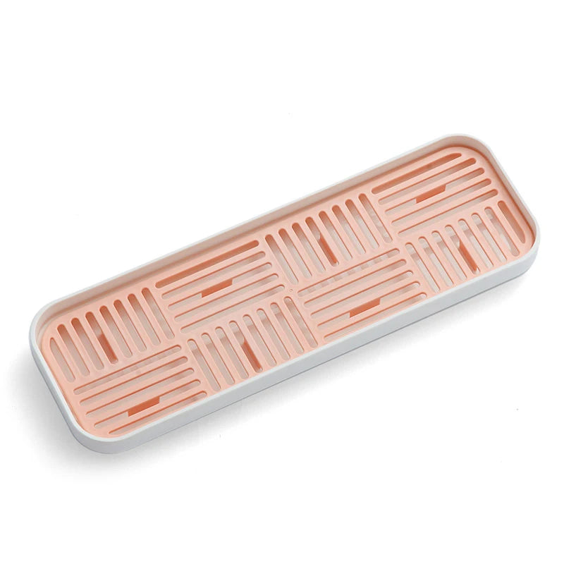 Petit égouttoir vaisselle plastique rose sur fond blanc