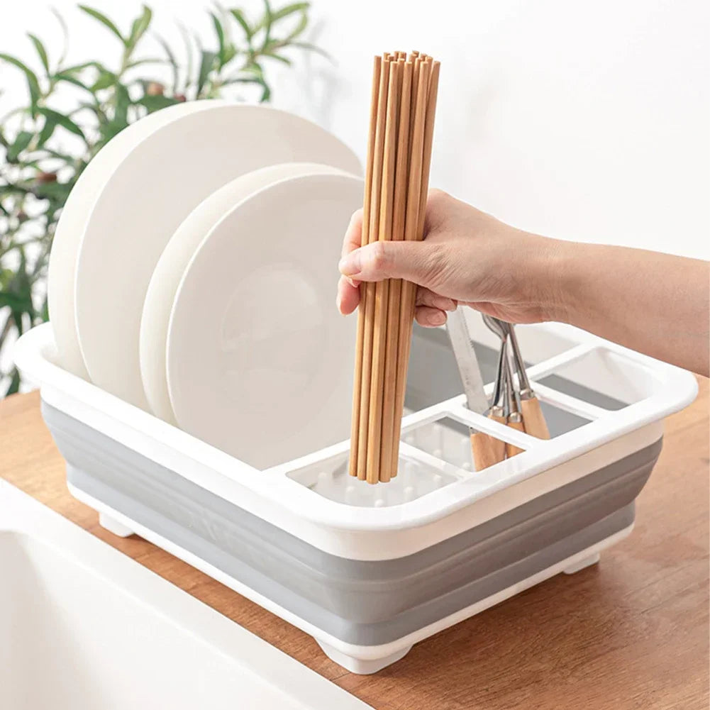 Main déposant des baguettes dans l'égouttoir vaisselle pliable